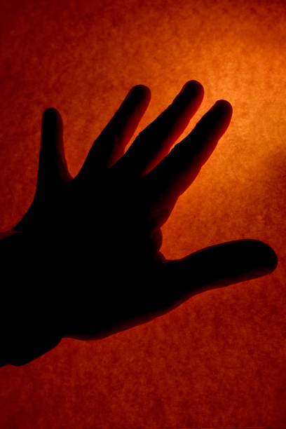 istock Hand silhouette in front of colored cardboard 2089859530