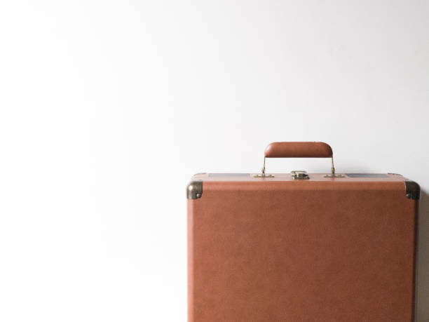 istock brown suitcase in front of white background 2089940591