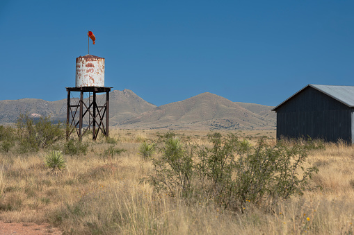 A rusted water tower and barn stand together along a country road in southeastern Arizona.