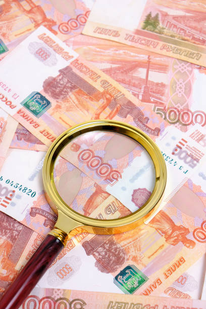 istock Magnifying magnifier against background Russian rubles with face value five thousand. 2090024813