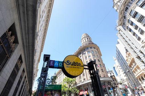 View of Gran Via street in the morning, Madrid, Spain. Tourists with suitcases near Callao Metro Station.