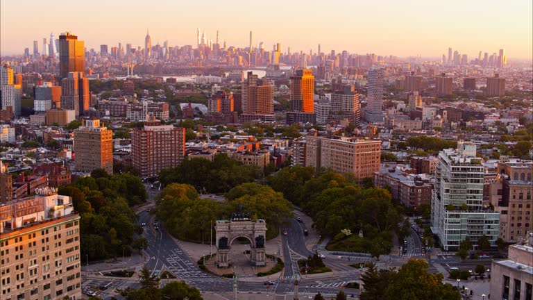 Historic Grand Army Plaza with Soldiers and Sailors Memorial Arch in Brooklyn, NY with panoramic view including Manhattan at the backdrop, at sunrise. Aerial video with the panning-orbiting camera motion.