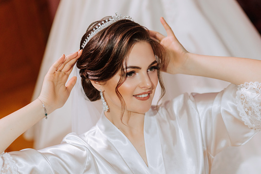 stylish hairstyle of the bride with a tiara on her head. A close-up of the hairstyle of a beautiful bride. The concept of a motif on the topic of a hairdresser, wedding and wedding preparations.
