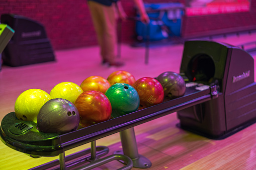 Close-up view of a bowling alley ball dispenser.