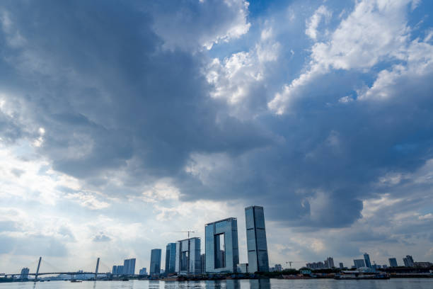 I am doing a hike in Xajiao, Guangzhou. I was carrying a Sony 16-35 f4 lens and I utilized the wide angle to take this photo. It was a beautiful sunny day. I spotted these skyscrapers standing by the river and they formed a city skyline with the bridge in the distance. I thought it was beautiful.