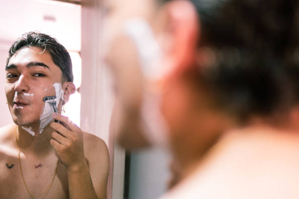 istock Reflection of Joyful Young Man Shaving in Bathroom 2090166390