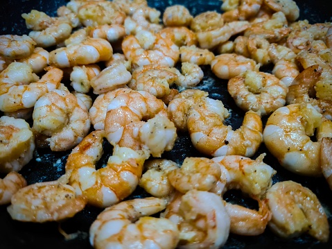 Cooked shrimp in a frying pan.