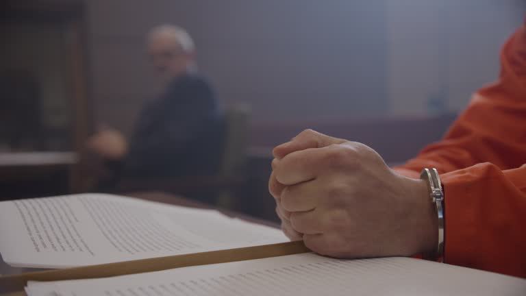 Inmate hands banging table during a court hearing