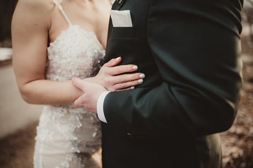 Bride and groom holding hands on their wedding day