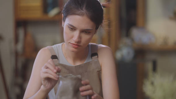 istock Artisan Sculpting and Refining Clay Pottery 2090325935
