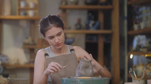 istock Artisan Sculpting and Refining Clay Pottery 2090326442