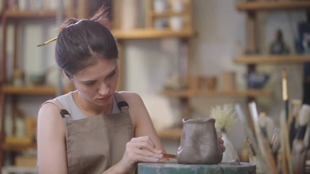 istock Artisan Sculpting and Refining Clay Pottery 2090326450