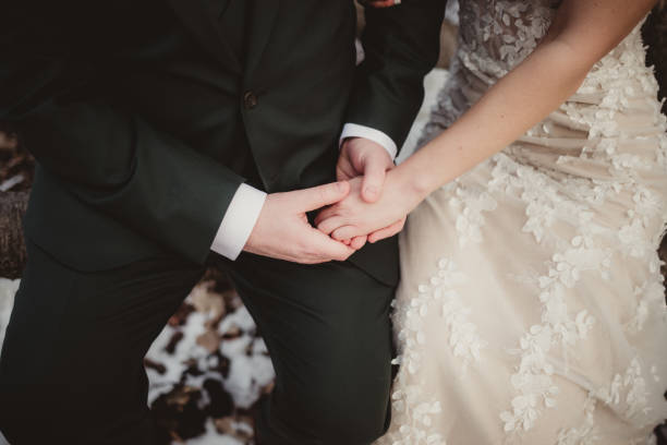 istock Bride and groom sitting and holding hands during wedding ceremony 2090331672