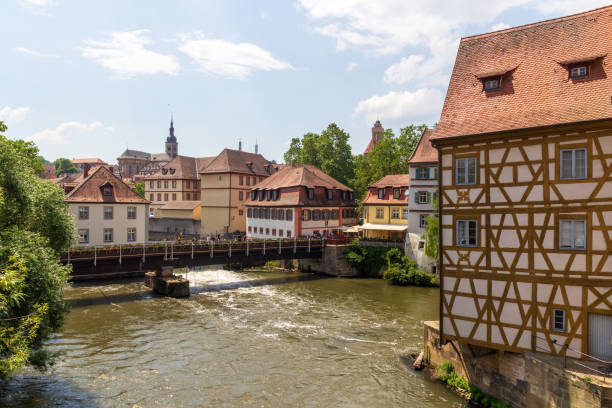 istock Panorama with bridge over river Regnitz with half-timbered house and St. Stephans church in Bamberg, Upper Franconia, Bavaria, Germany 2090343827