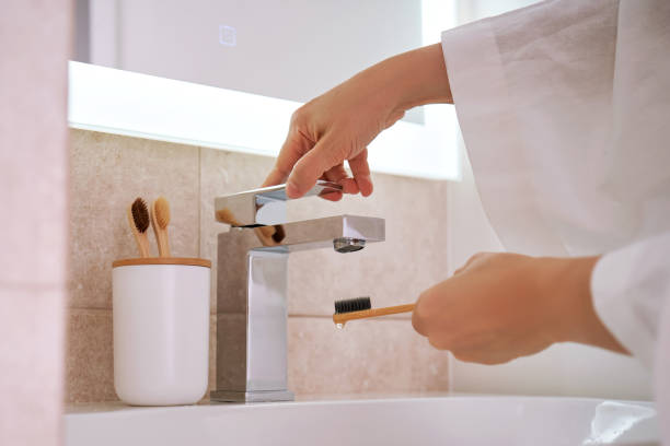 istock Women's hands under running water in the bathroom. Morning routine. 2090349989