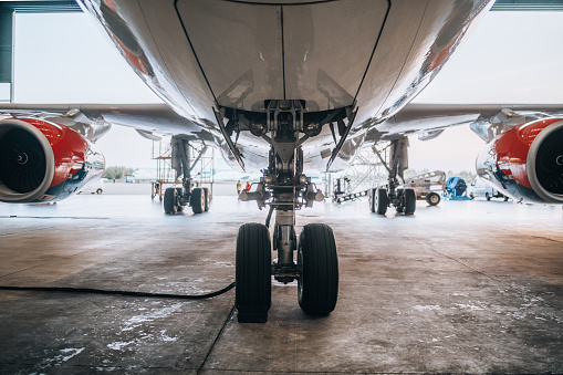 The landing gear of the aircraft standing at the airport hunger for maintenance.