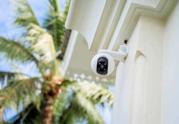 Modern CCTV camera on a wall of a residential building stock photo
