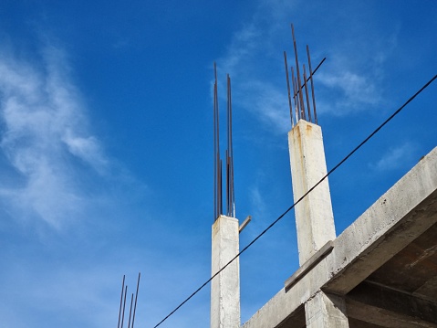 Unfinished concrete building with protruding metal reinforcement