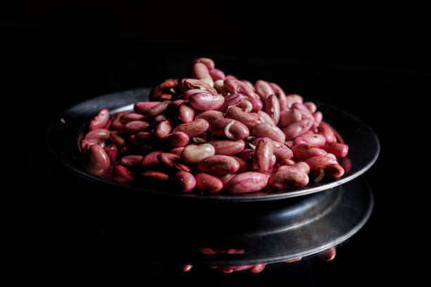 Bowl of pinto beans on white background