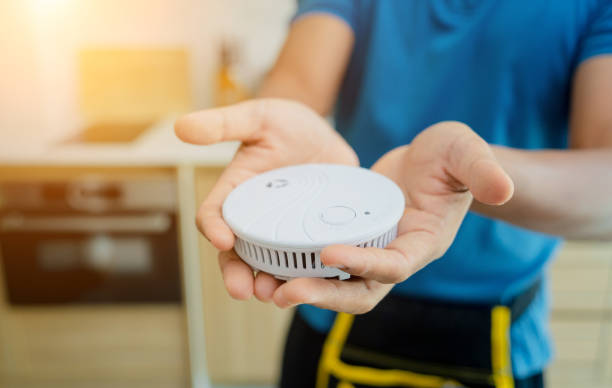 istock Technician installing fire safety detector in a modern apartment 2090477313