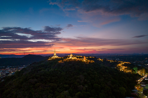 Aerial view by drone during twilight over Phra Nakhon Khiri Historical Park It is decorated with beautiful lights, commonly known as Khao Wang. summer palace, Mueang Phetchaburi District, Phetchaburi.