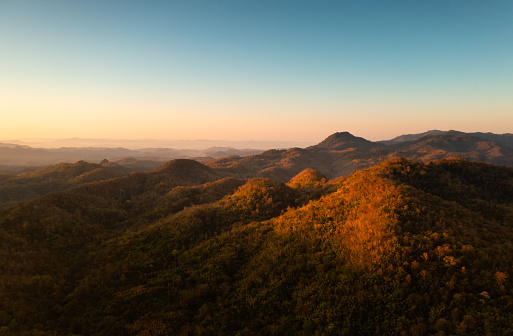 A cloudless sky, high mountains, and morning scenery. cozy ambiance in the fall. Lampang, Thailand.