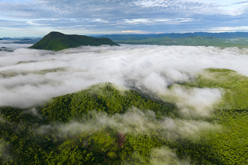A stunning aerial view of the morning mist that covers the surrounding mountains. Nong Ya Plong District in Phetchaburi, Thailand.