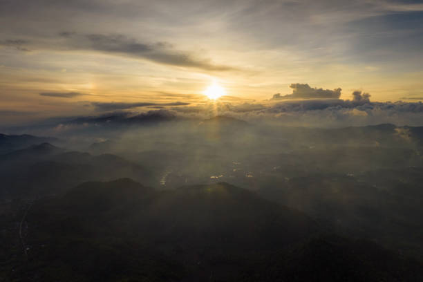 Aerial photography, The morning sun rises over a sea of mist, casting warm light.