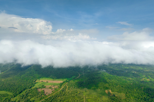 Cloudscape over mountains, aerial view, beautiful scenery in the morning, with a sea of mist moving over the high mountain forests.