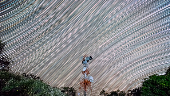 Long-exposure night photography with star trails Repeater station on a high mountain, Mae Moh District, Lampang Province, Thailand.