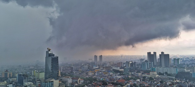 Jakarta, Indonesia - Mar 17, 2024: Aerial landscape picture of dark cloud and raining area in Jakarta