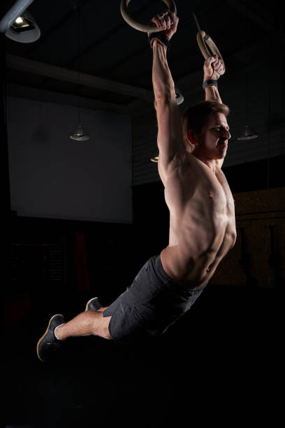 istock Fit man swinging on gymnastic rings 2090589729