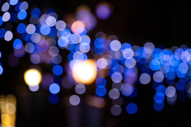 Blurred light halo, string light spot with black dark background at night.
