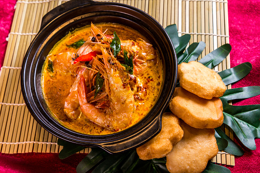 braised tiger big prawn with Indonesia curry soup in hot clay pot and deep fried mantou bun restaurant chinese banquet halal food asian cafe menu