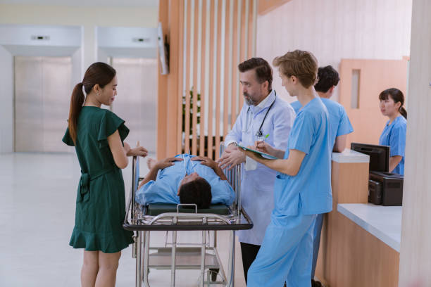 istock Doctors and nurses are waiting to transfer a patient lying on a bed for treatment, with relatives closely watching over him. 2090606549