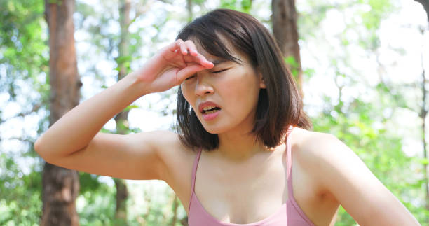 istock woman wipes sweat after exercise 2090609188