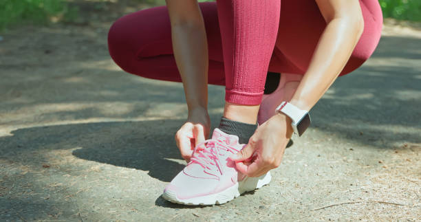 istock asian woman tie tight shoelace 2090611781