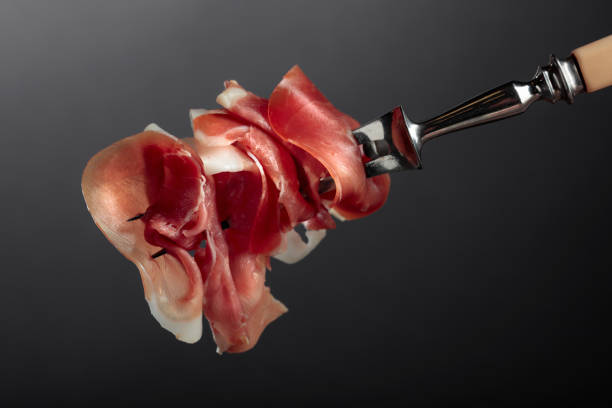 istock Slices of prosciutto on a fork. 2090672362