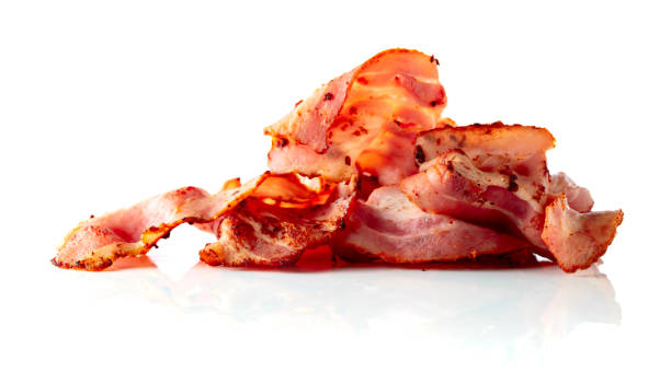 Fried bacon slices isolated on white. Fried bacon slices isolated on white background. cooked bacon slice stock pictures, royalty-free photos & images