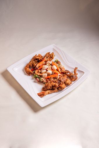 chinese and western mixed seafood combination cold platter with deep fried soft shell crab scallop salad on wood table asian restaurant banquet halal food cafe menu