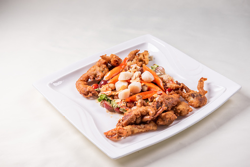 chinese and western mixed seafood combination cold platter with deep fried soft shell crab scallop salad on wood table asian restaurant banquet halal food cafe menu