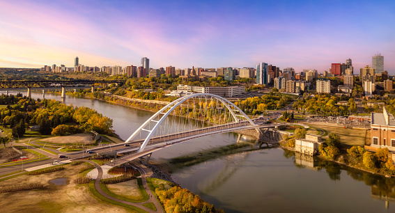 An aerial of a bridge over the river with the city in the background in Edmonton, Alberta, Canada.