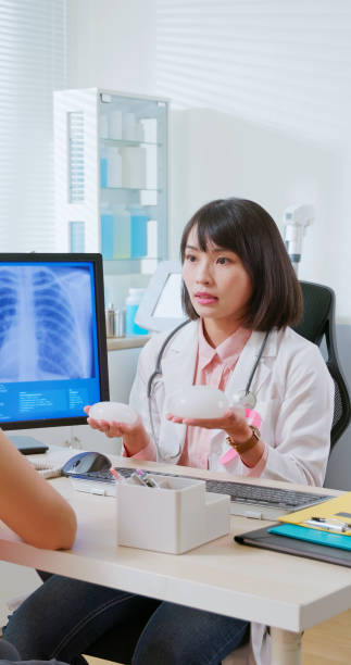 istock Asian doctor explain breast implant 2090740674