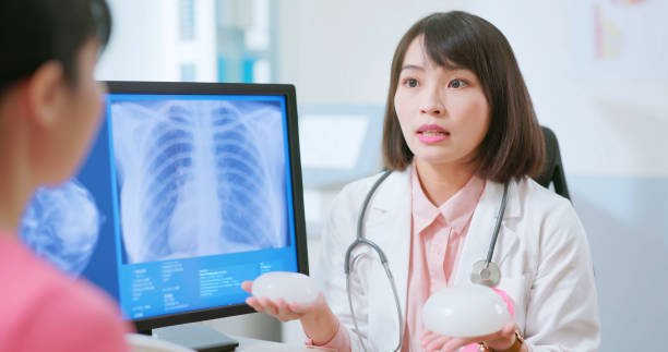 istock Asian doctor explain breast implant 2090741725
