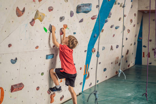 istock Boy at the climbing wall without a helmet, danger at the climbing wall 2090806822