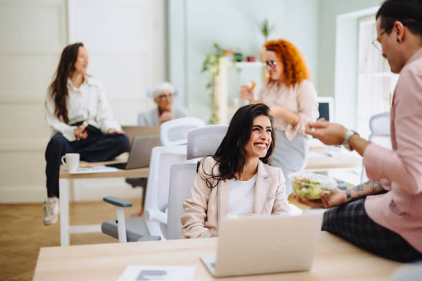 istock Happy colleagues having a lunch break in an office 2090828632