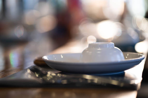 Cups and plates on the dining table bokeh light background.