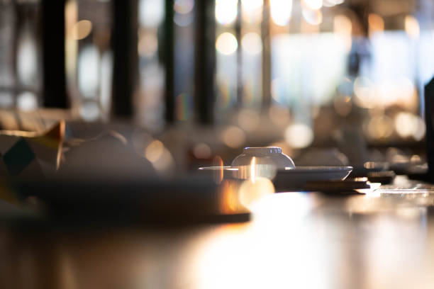 Cups and plates on the dining table bokeh light background.