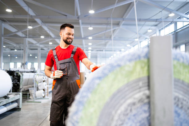 istock Working in carpet factory. Industrial textile machines in background. 2090882018