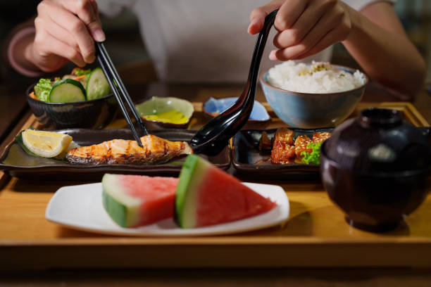 istock In the cropped image, a woman's hand is using chopsticks to enjoy grilled salmon bento in a Japanese restaurant. 2090901633